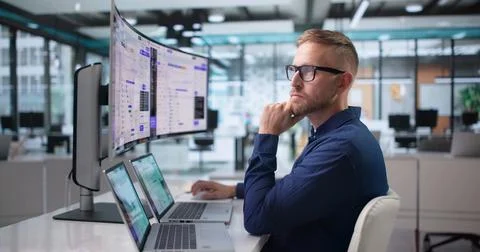 Software Engineer Carefully Monitors AI Orchestration Dashboard On Ultrawide  Stock Photos