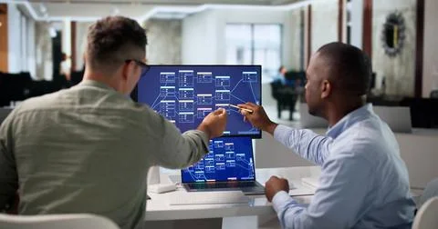 Software Engineer Collaborates With Team Using No Code Platform Tools. Stock Photos