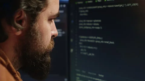 Software engineer concerned, concentrating on finding code bugs, close up Stock Footage 265510287