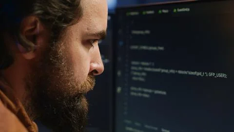 Software engineer concerned, concentrating on finding code bugs, close up Stock Photos