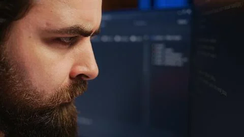 Software engineer concerned, concentrating on finding code bugs, close up Stock Photos