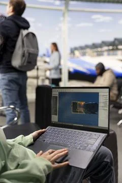 Software engineer creating gaming assets for video game in the airport lounge Stock Photos
