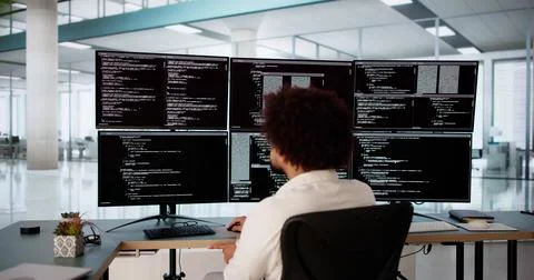 Software Engineer Debugging Code At Desk Stock Photos
