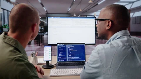 Software Engineer Debugging Mobile Phone App On Desktop Stock Footage 334922249