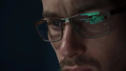 Software engineer in glasses working on big data, with code reflecting on lenses Stock Footage 303998406