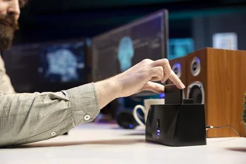 Software engineer inserting disk in computer with rogue self aware AI Stock Photos