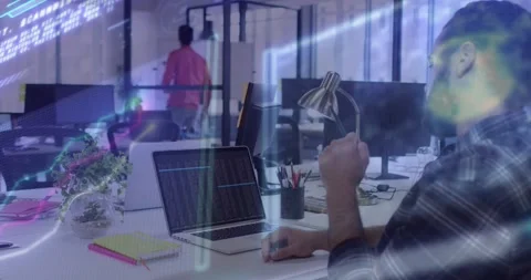 Software engineer pausing typing, examining device on colleague pass to test Stock Footage 318544794