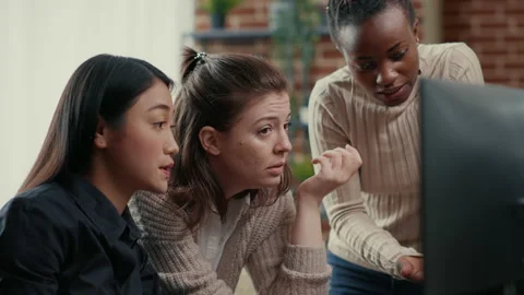 Software engineer pointing at computer screen explaining running code to Stock Footage 168248087