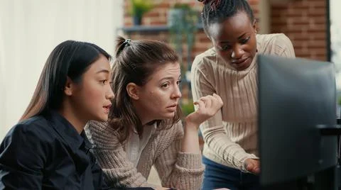 Software engineer pointing at computer screen explaining running code to 写真素材