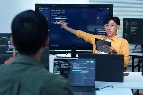 Software Engineer Presenting Code to Development Team Stock Photos