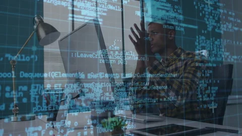 Software engineer reviewing code overlay then calling via smartphone to discuss Stock Footage 314709056