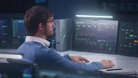 Software engineer sits in front of computer with blockchain network Stock Footage 244412915