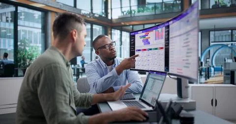Software Engineer Studies Split Test Data On Laptop To Enhance Conversions. Stock Photos