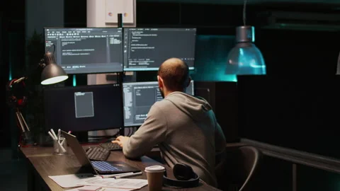 Software engineer typing source code on multiple monitors Stock Footage 222842129