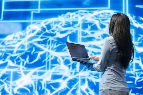 Software engineer using laptop software to review artificial intelligence model Stock Photos