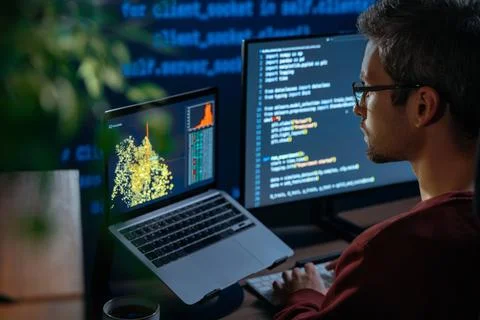 Software engineer working late at night on artificial intelligence project Stock Photos