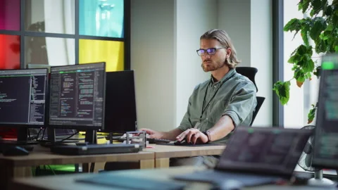 Software Engineer Working On Mobile Application In Office Stock Footage 223193097