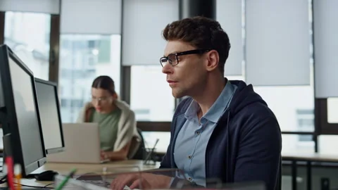 Software engineer working office. Focused man developer typing desktop computer Stock Footage 242981328