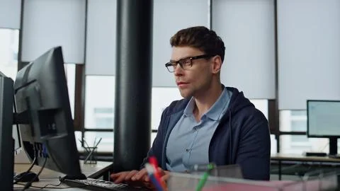 Software engineer working office. Focused man developer typing desktop computer 스톡 사진