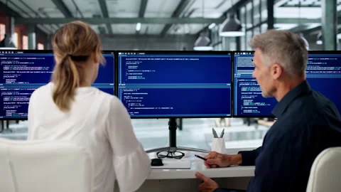 Software Engineers Collaborate Closely At Desks Stock Footage 336791932