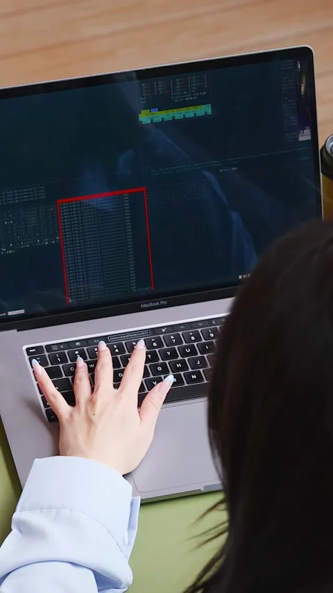 Software Engineers Collaborating Over Laptop Code in Modern Office Stock Footage 346664529