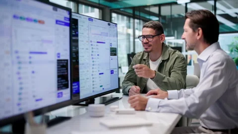 Software Engineers Collaboratively Evaluate AI Orchestration Workflows Stock Footage 347292633