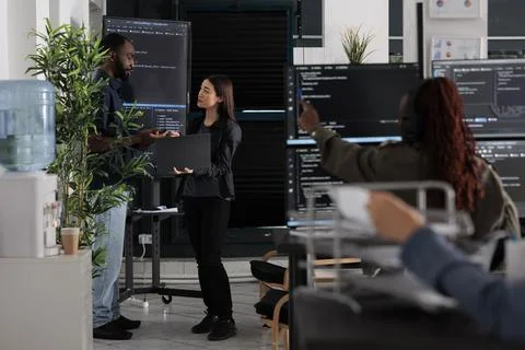 Software engineers discussing about algorithms on big screen Stock Photos