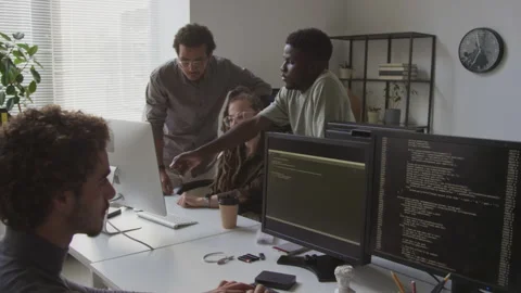 Software Engineers Discussing Computer Program at Workplace Stock Footage 255781431