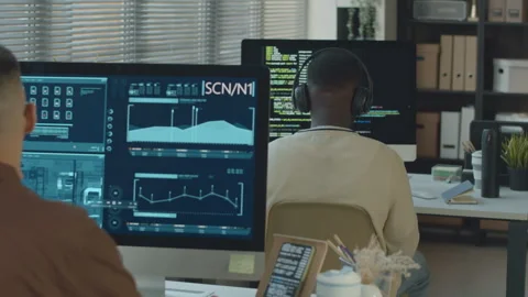 Software Engineers Examining Chip Interface and Coding in Office Stock Footage 259150466