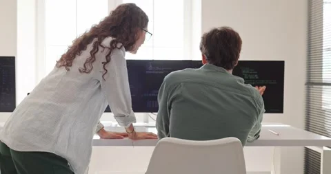 Software Engineers Reviewing Programming Code on Office Computer Monitors Stock Footage 345680027