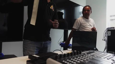 Software engineers setting up a desk with hardware and taping down cables Video stock 244786707