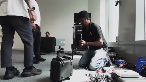 Software engineers setting up monitors for an event Stock Footage 244787430