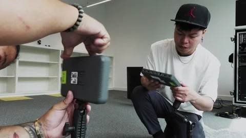 Software engineers setting up small monitors for a live streaming event Stock Footage 244787962