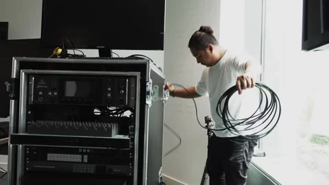 Software engineers unraveling cables to plug into hardware Video stock 244786701