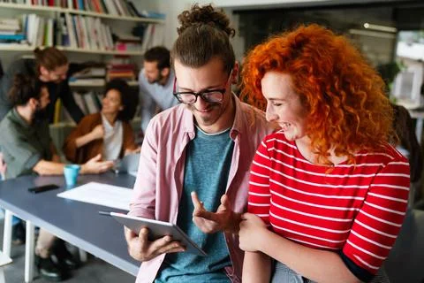 Software engineers working together on project at tech startup. Business de.. Stock Photos