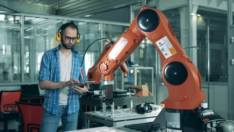 Software expert is analyzing a robotic machine in motion Stock Footage 135588218