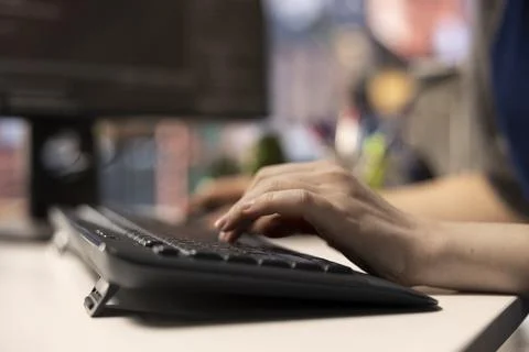 Software expert at workstation programming on pc and writing lines of code Stockfoto's