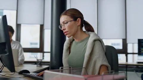 Software manager typing computer in office. Upset woman developer solve problem Stock Footage 242986556