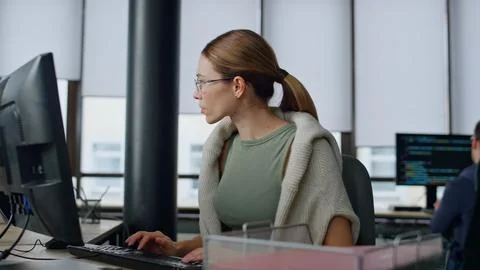 Software manager typing computer in office. Upset woman developer solve problem Stock Photos