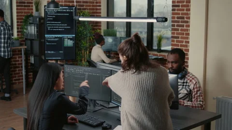 Software programer pointing pencil at source code on computer screen explaining Stock Footage 168235024