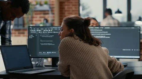 Software programer putting laptop with source code on colleague coder desk Stock Photos