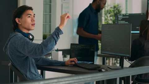 Software programer writing code and using holographic program with augmented Video stock 220705603