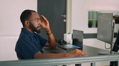 Software programer writing program code to develop database system Stock Footage 221375382