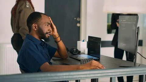 Software programer writing program code to develop database system Photos