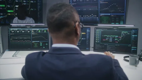 Software programmer sits in front of computer with blockchain network Stock Footage 244412070