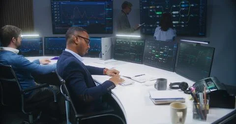 Software programmer sits in front of computer with blockchain network Stock Photos