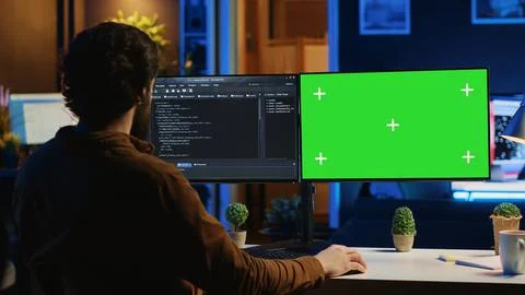 Software programmer writing lines of code on chroma key computer at home Stock Photos