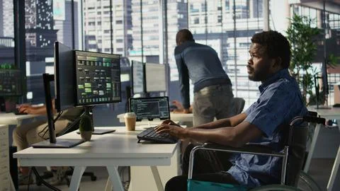 Software technician with disability in inclusive workplace working Stockfoto's