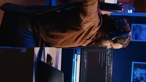 Software technician typing code in neon lit personal office Stock Footage 265108853