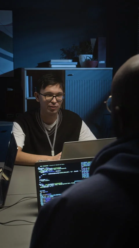 Software Tester Chatting with Web Developer Working on Laptops in Dark IT Office Video stock 329615629
